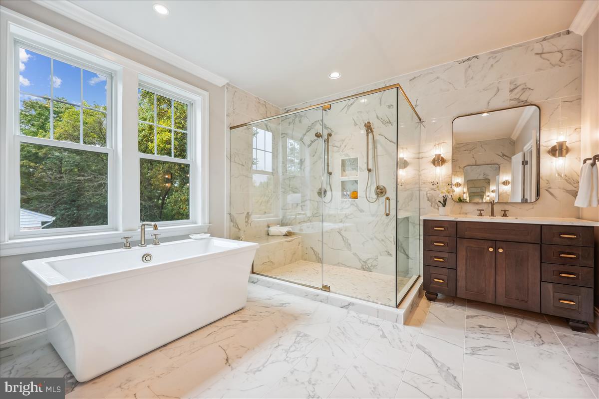 7600 Massena Road Bethesda, MD 20817 - Photo 58 of 102 a spacious bathroom with a tub sink shower and mirror