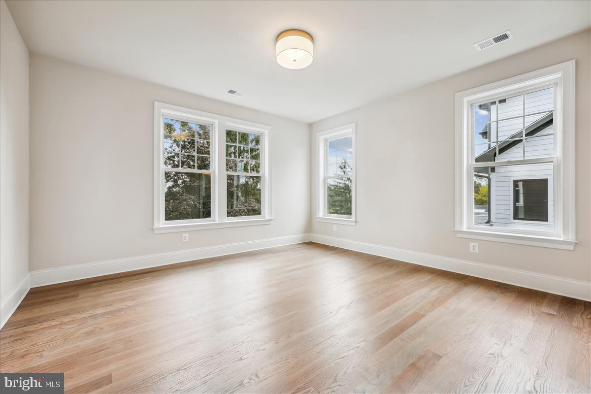 7600 Massena Road Bethesda, MD 20817 - Photo 62 of 102 a view of an empty room with wooden floor and a window
