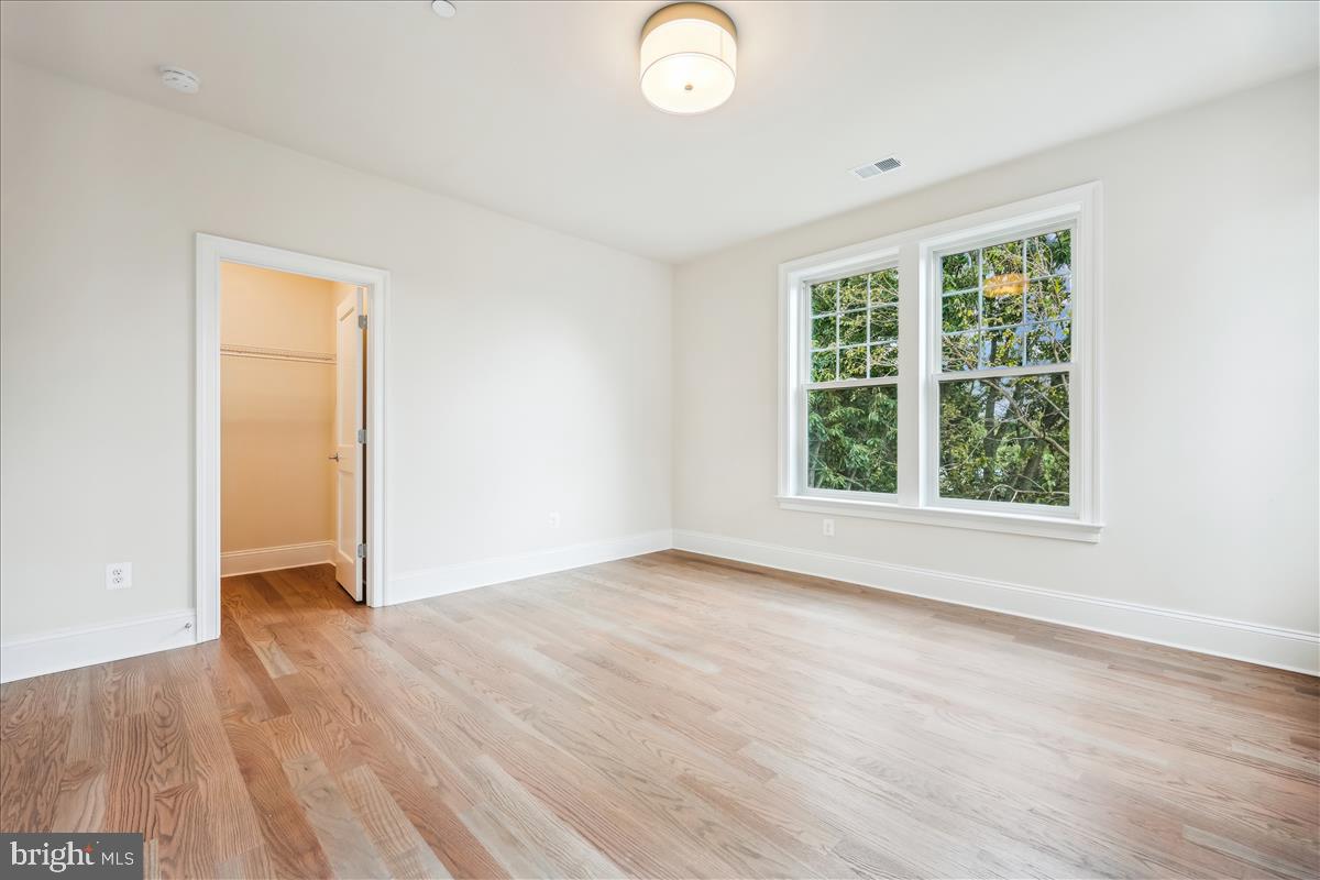 7600 Massena Road Bethesda, MD 20817 - Photo 63 of 102 an empty room with wooden floor and windows