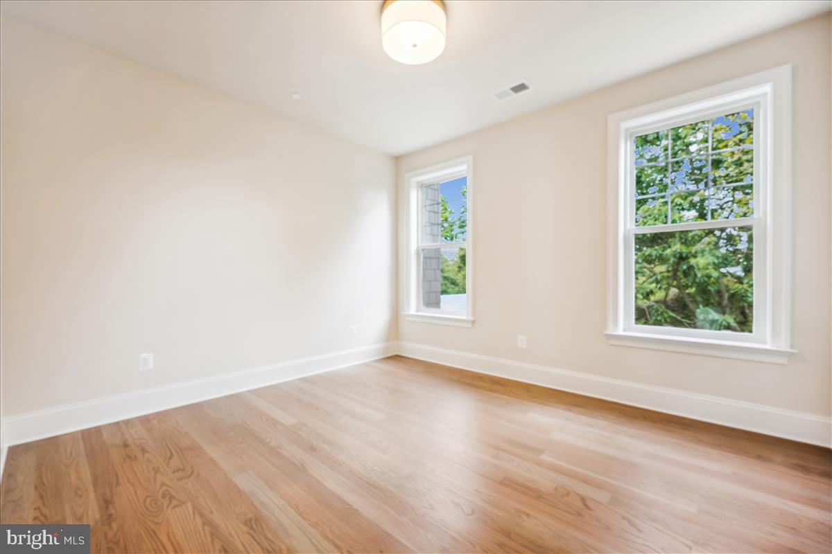 7600 Massena Road Bethesda, MD 20817 - Photo 66 of 102 an empty room with wooden floor and windows