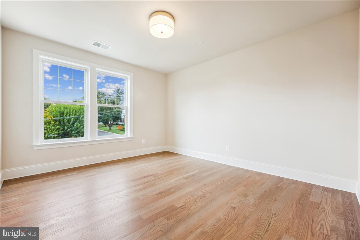 7600 Massena Road Bethesda, MD 20817 - Photo 68 of 102 an empty room with wooden floor and windows