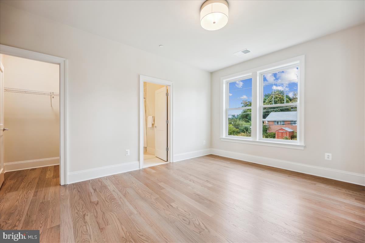 7600 Massena Road Bethesda, MD 20817 - Photo 70 of 102 an empty room with wooden floor and windows