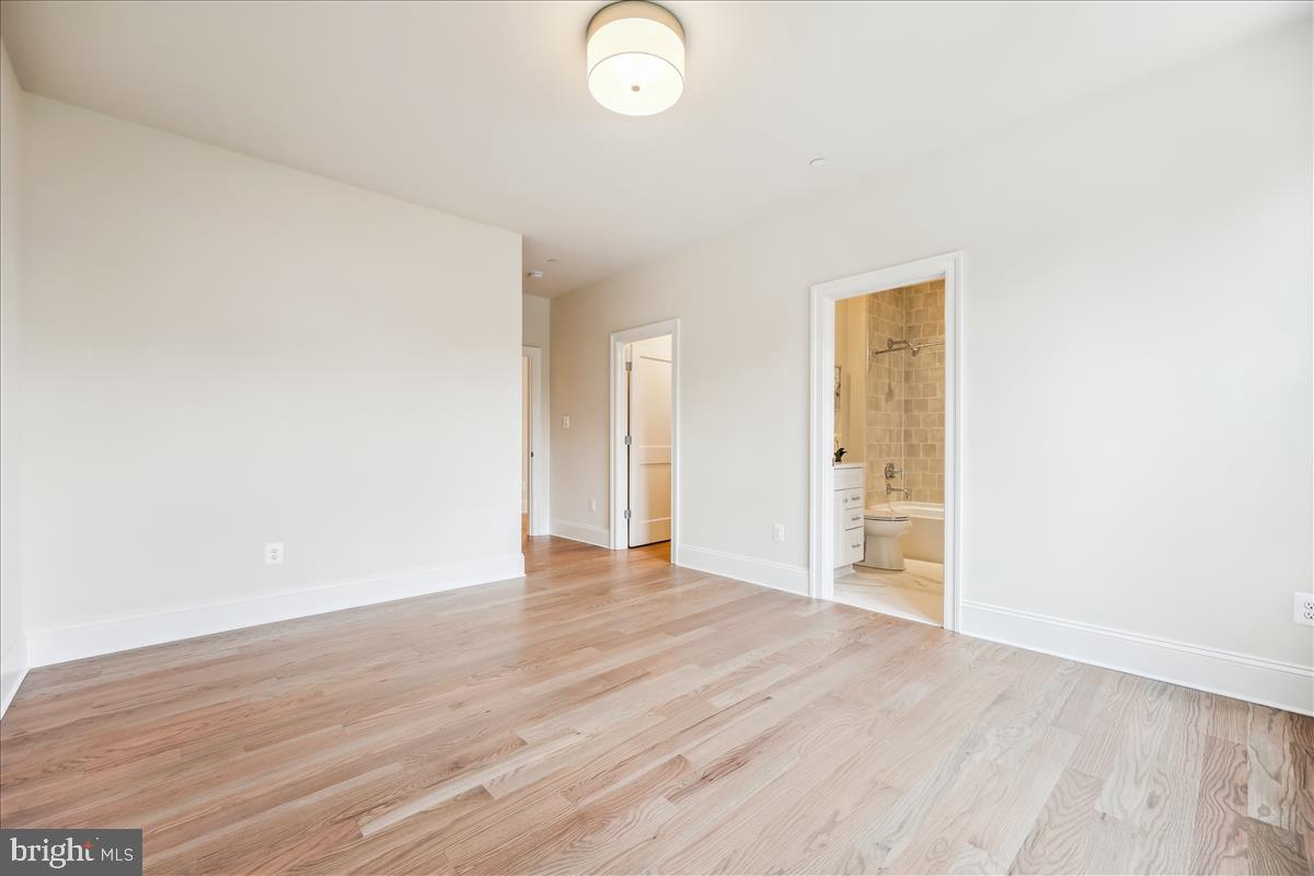 7600 Massena Road Bethesda, MD 20817 - Photo 71 of 102 a view of an empty room with wooden floor and a window