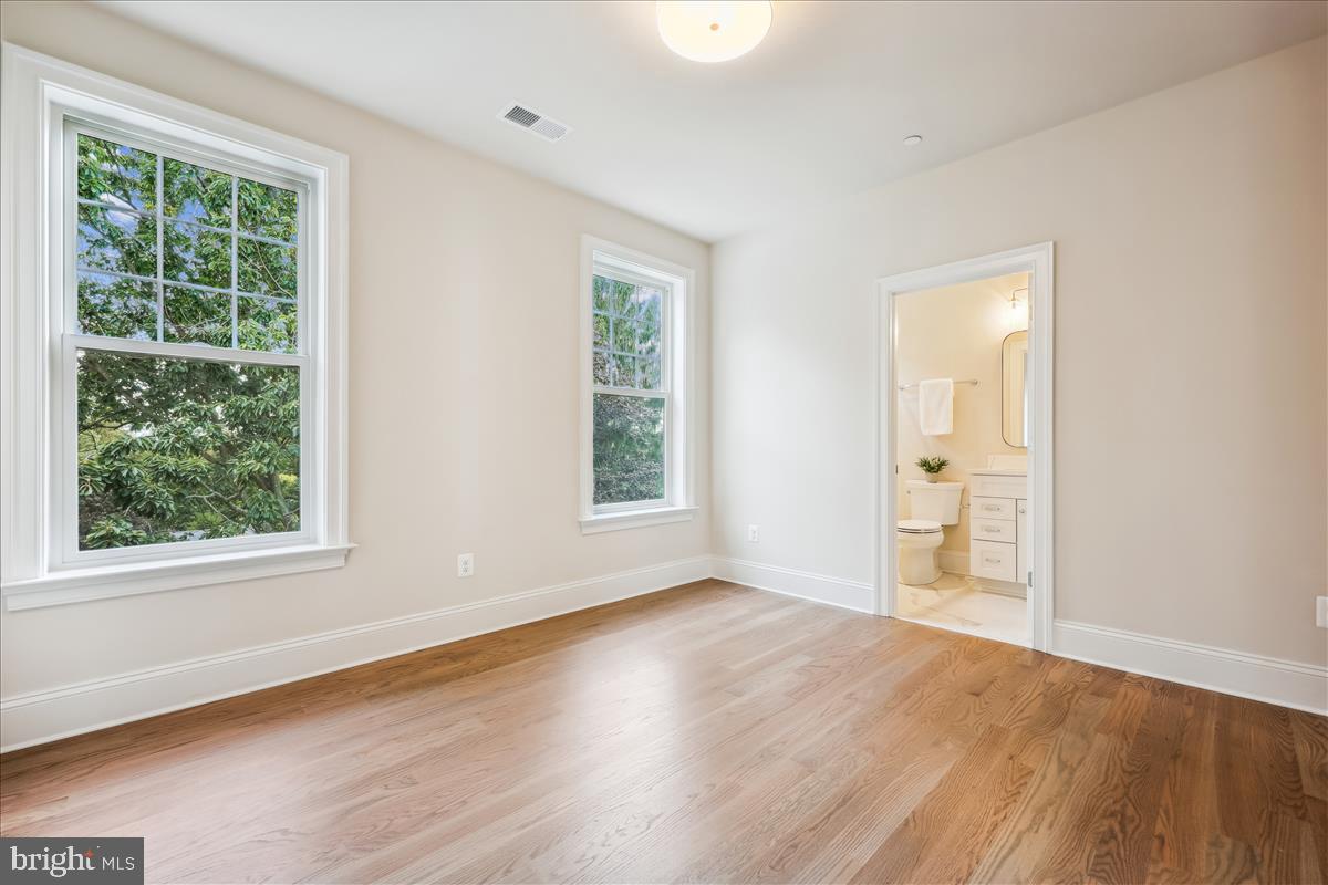 7600 Massena Road Bethesda, MD 20817 - Photo 72 of 102 an empty room with wooden floor and windows