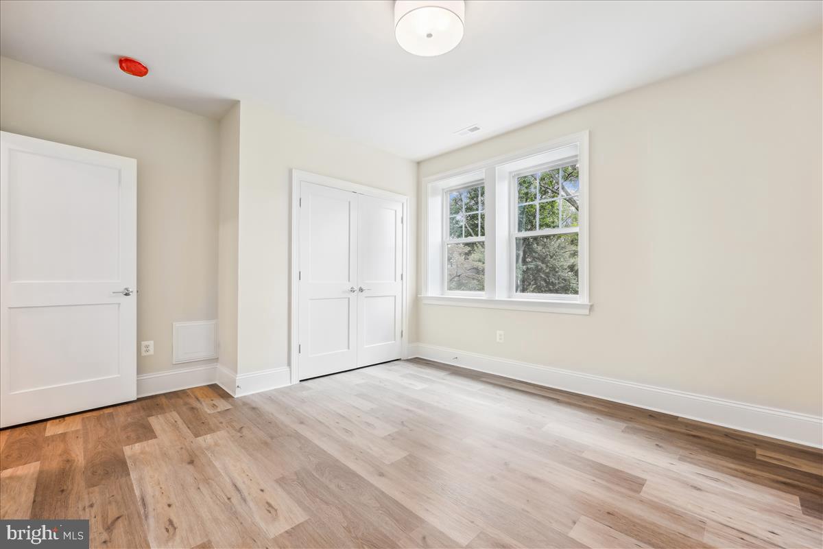 7600 Massena Road Bethesda, MD 20817 - Photo 77 of 102 an empty room with wooden floor and windows