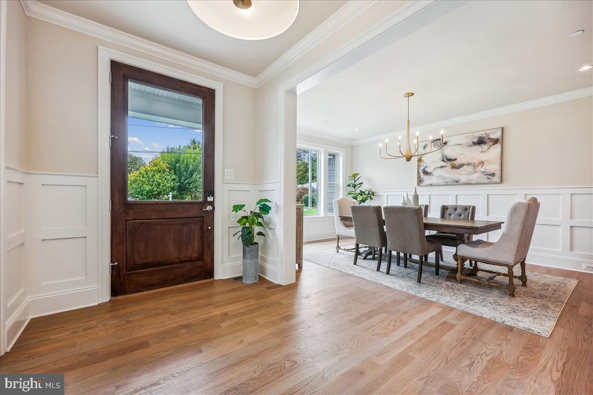 7600 Massena Road Bethesda, MD 20817 - Photo 8 of 102 a view of a dining room with furniture and wooden floor