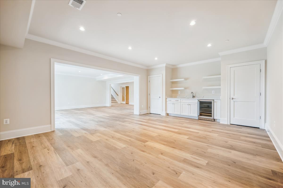 7600 Massena Road Bethesda, MD 20817 - Photo 86 of 102 a view of empty room with wooden floor and kitchen