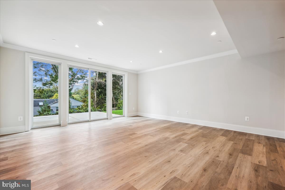 7600 Massena Road Bethesda, MD 20817 - Photo 90 of 102 a view of an empty room with wooden floor and a window