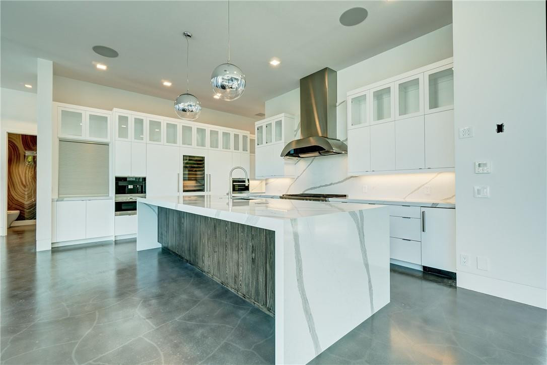 424 Northeast 5th Street Boca Raton, FL 33432 - Photo 12 of 51 a kitchen with kitchen island a sink stainless steel appliances and cabinets