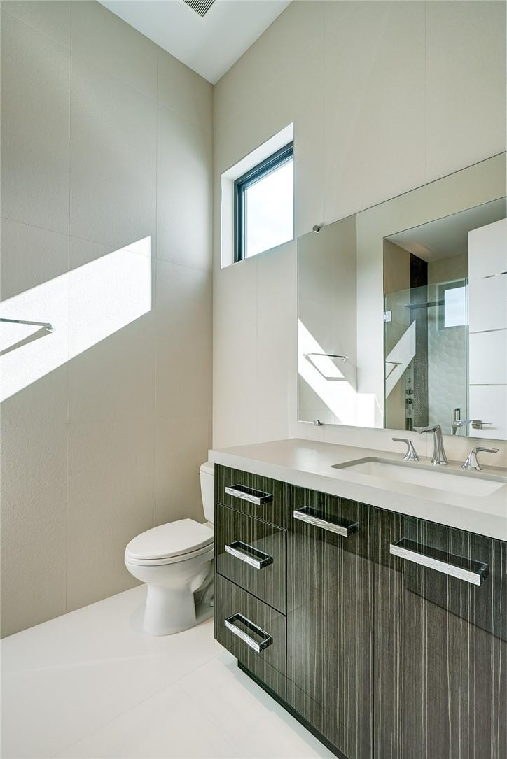 424 Northeast 5th Street Boca Raton, FL 33432 - Photo 36 of 51 a bathroom with a granite countertop toilet sink and mirror