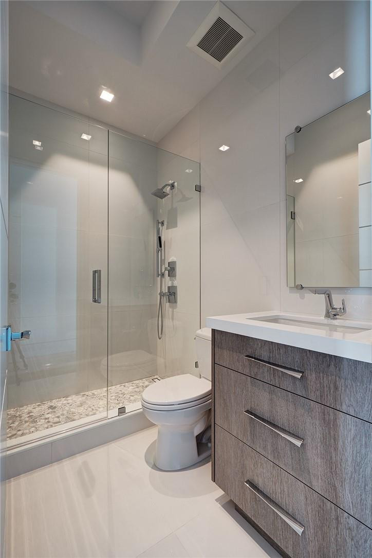 424 Northeast 5th Street Boca Raton, FL 33432 - Photo 39 of 51 a bathroom with a double vanity sink toilet and shower