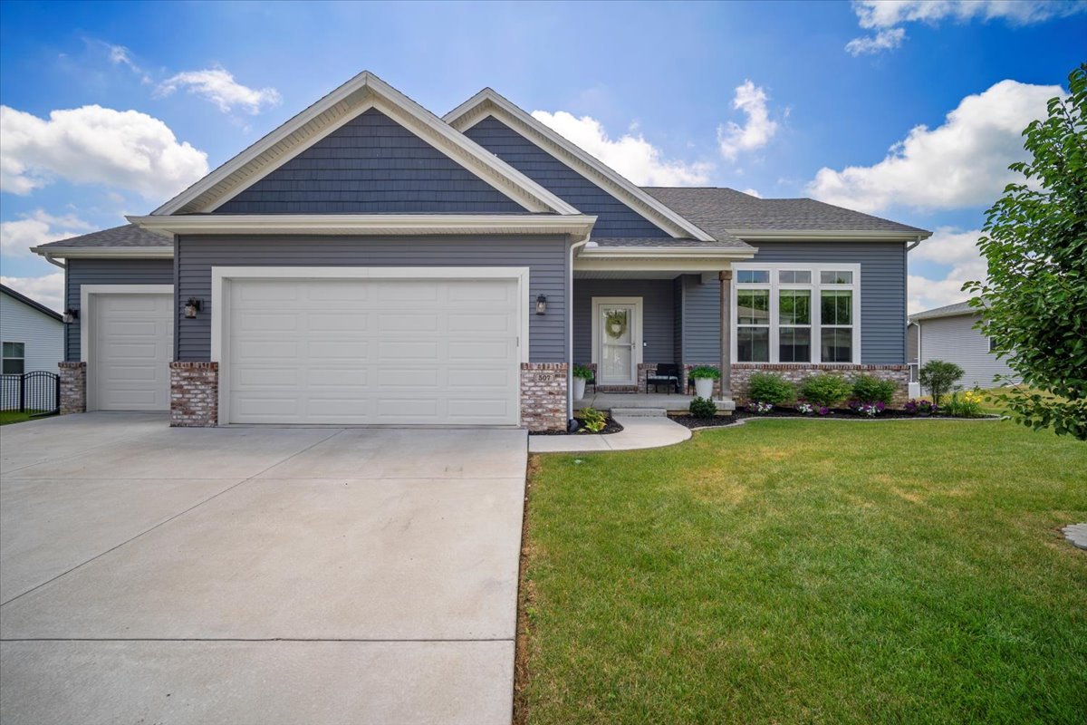 a front view of a house with a yard and garage