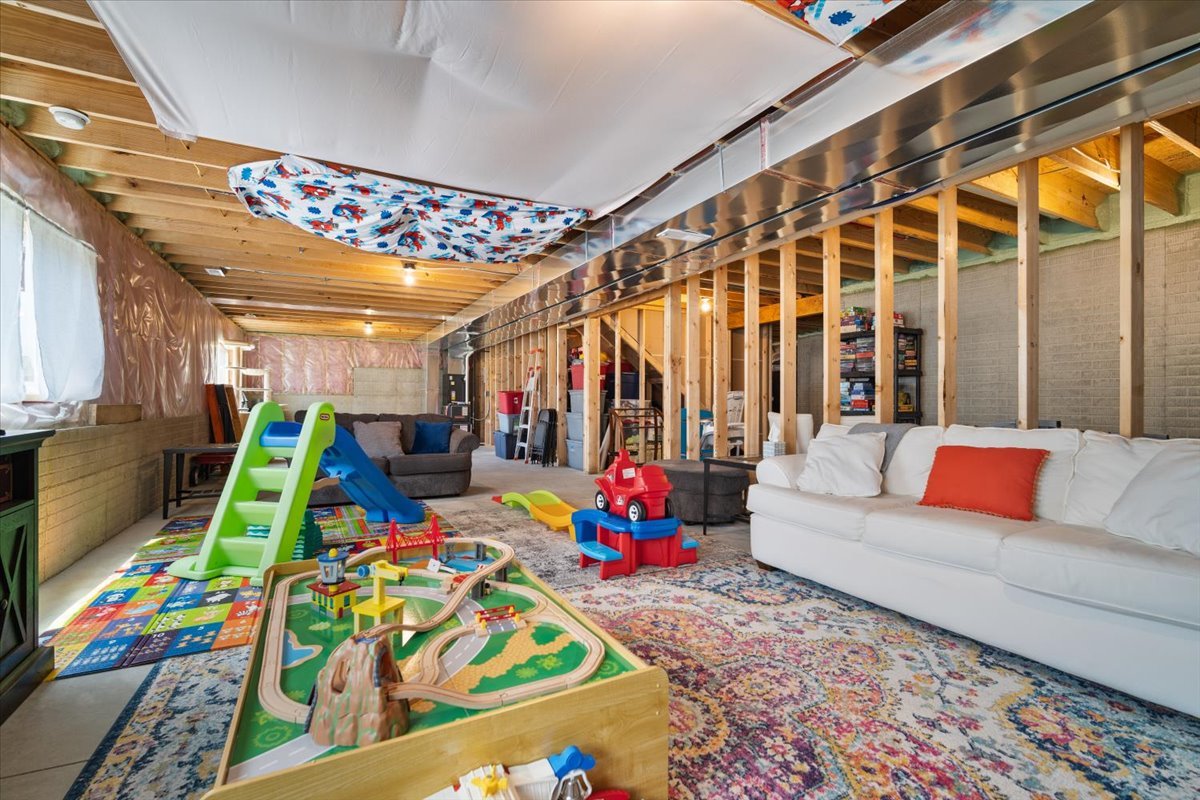 507 Raef Road Downs, IL 61736 - Photo 31 of 37 a living room with patio furniture and a flat screen tv