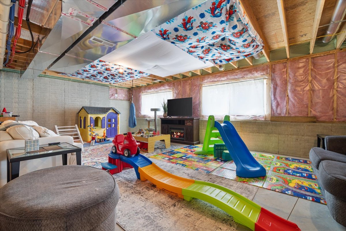 507 Raef Road Downs, IL 61736 - Photo 32 of 37 a living room filled with furniture and a flat screen tv