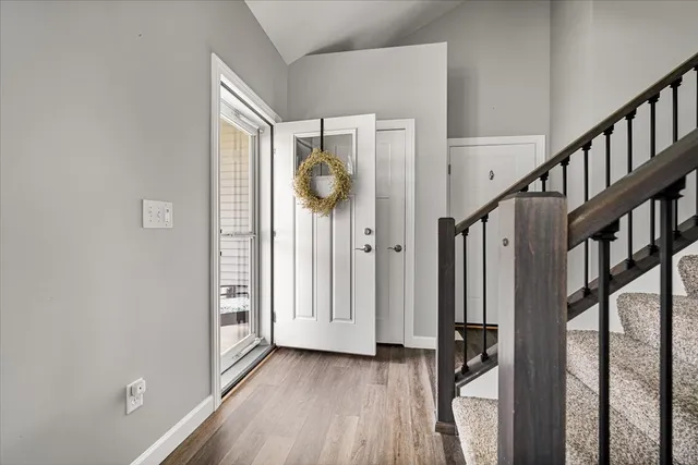 a view of an entryway with wooden floor