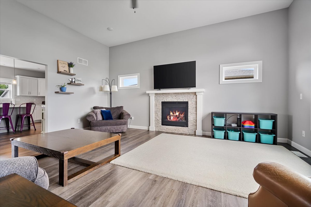 507 Raef Road Downs, IL 61736 - Photo 8 of 37 a living room with furniture a flat screen tv and a fireplace