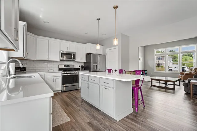 a kitchen with a sink stove and microwave