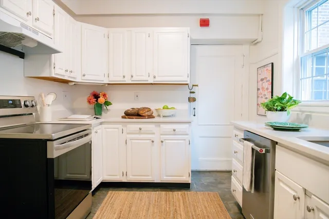 a view of a dining room with a table and chairs