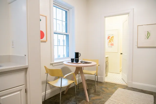 a large bed sitting in a bedroom next to a window