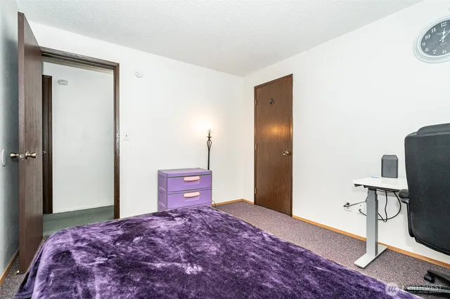 a bedroom with a bed and a table in it