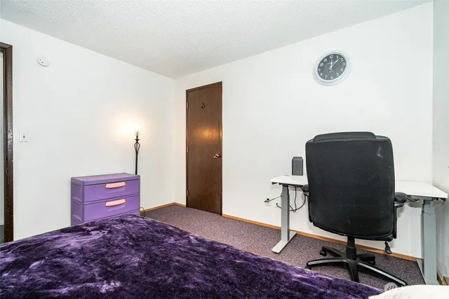 a bedroom with a bed and a chair