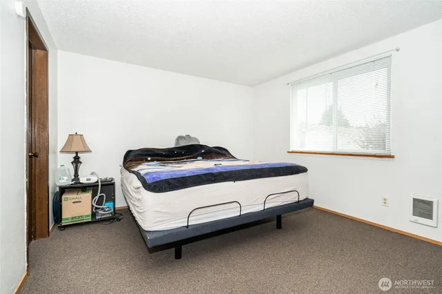 a bedroom with a bed and a window