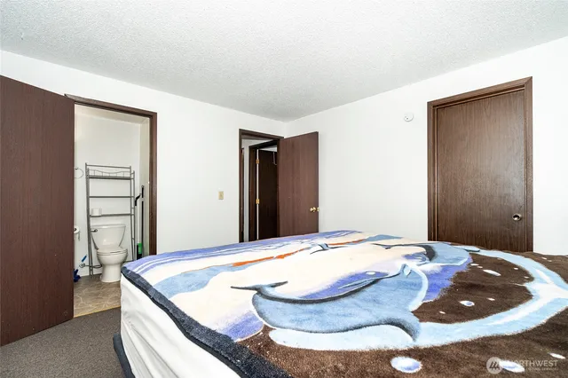 a bedroom with a bed and a dresser