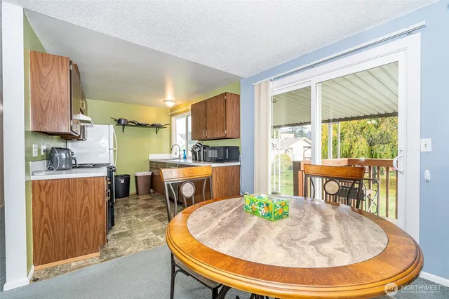 a dining room with a table and chairs