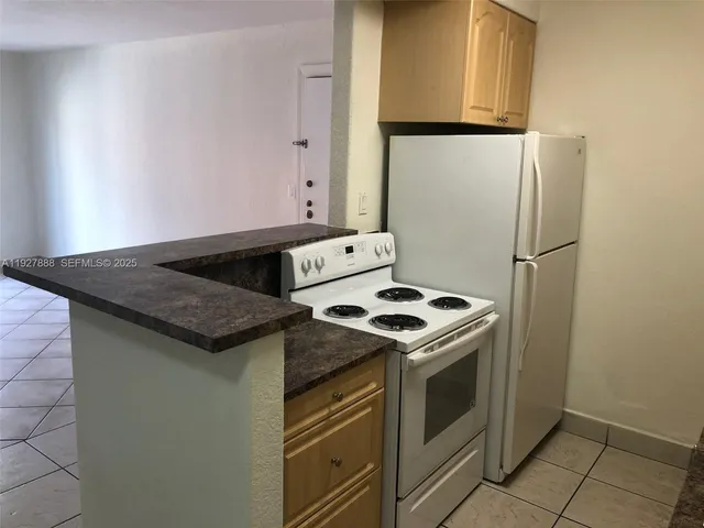 a stove top oven sitting inside of a kitchen