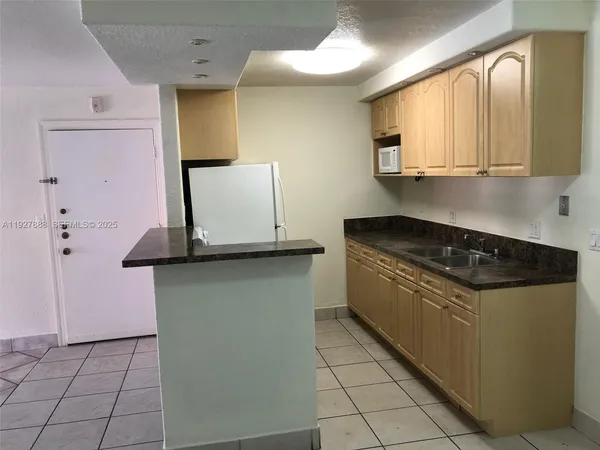 a kitchen with stainless steel appliances granite countertop a stove and a microwave