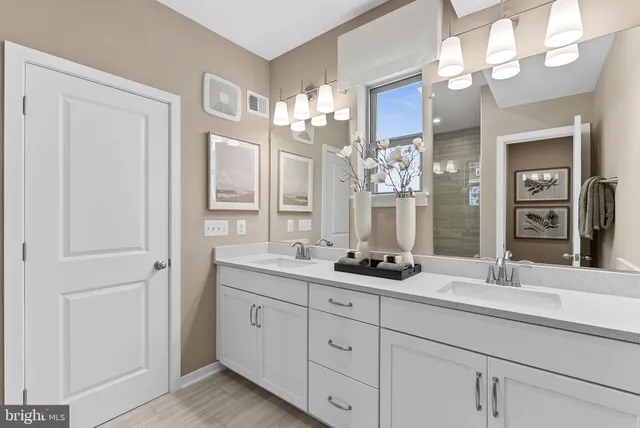 a bathroom with a sink double vanity and a mirror