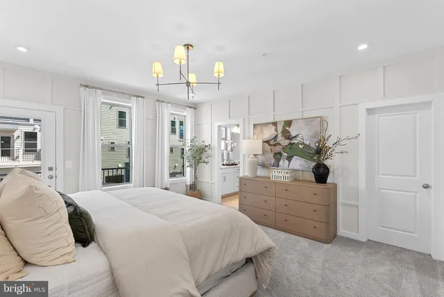 a bedroom with furniture and a chandelier