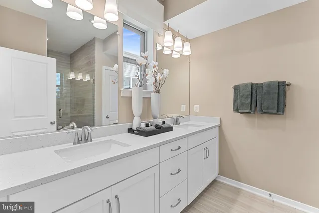 a bathroom with a double vanity sink mirror and