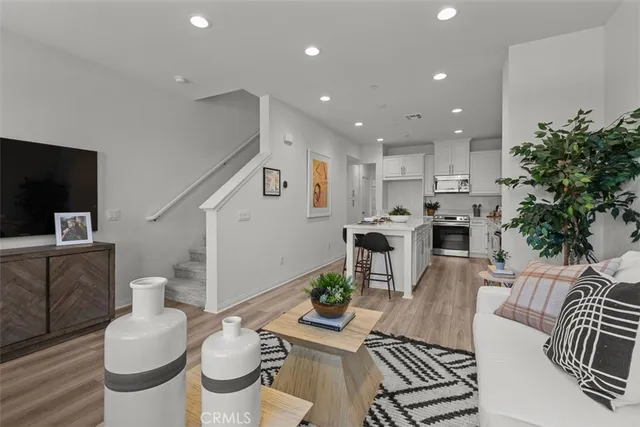 a kitchen with kitchen island a counter top space a sink stainless steel appliances and cabinets