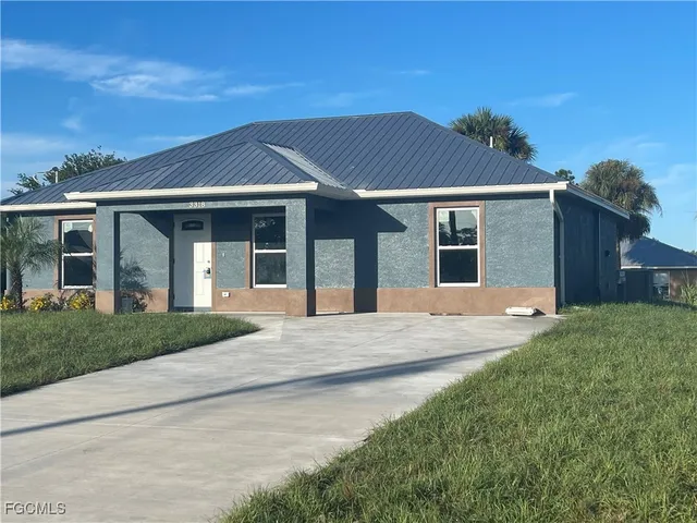 front view of a house with a garden