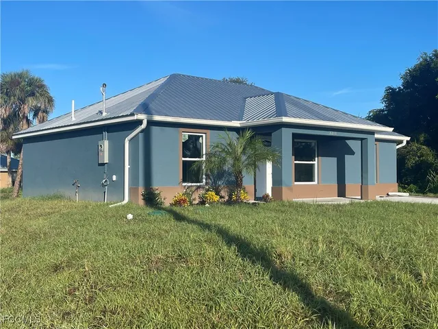 a view of a house with backyard and porch