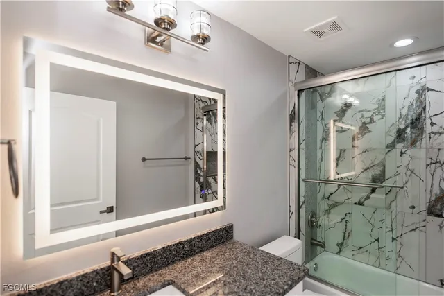 a bathroom with a shower and a sink