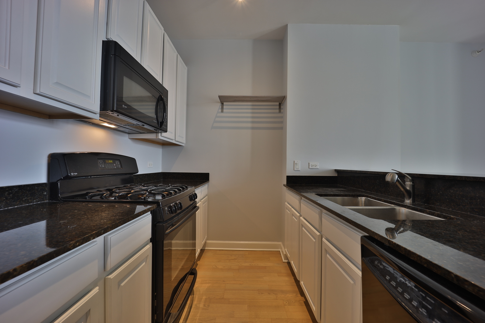 233 East 13th Street, Unit 1708 Chicago, IL 60605 - Photo 7 of 15 a kitchen with stainless steel appliances granite countertop a sink and a stove