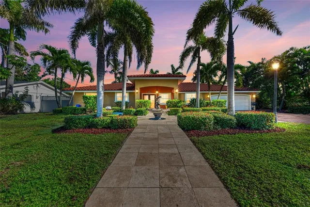 a view of a patio with table and chairs and potted plants with wooden floor and fence