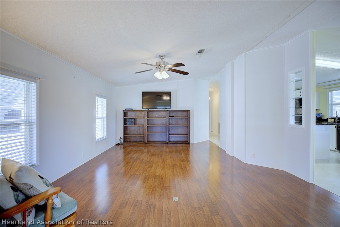 2702 Rodney Street Sebring, FL 33872 - Photo 4 of 33 a view of workspace with wooden floor and ceiling fan