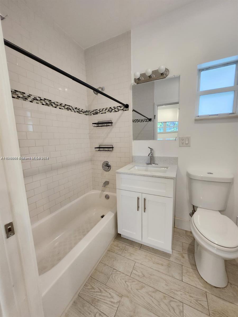 261 Northwest 50th Street, Unit R Miami, FL 33127 - Photo 7 of 10 a bathroom with a sink toilet and shower