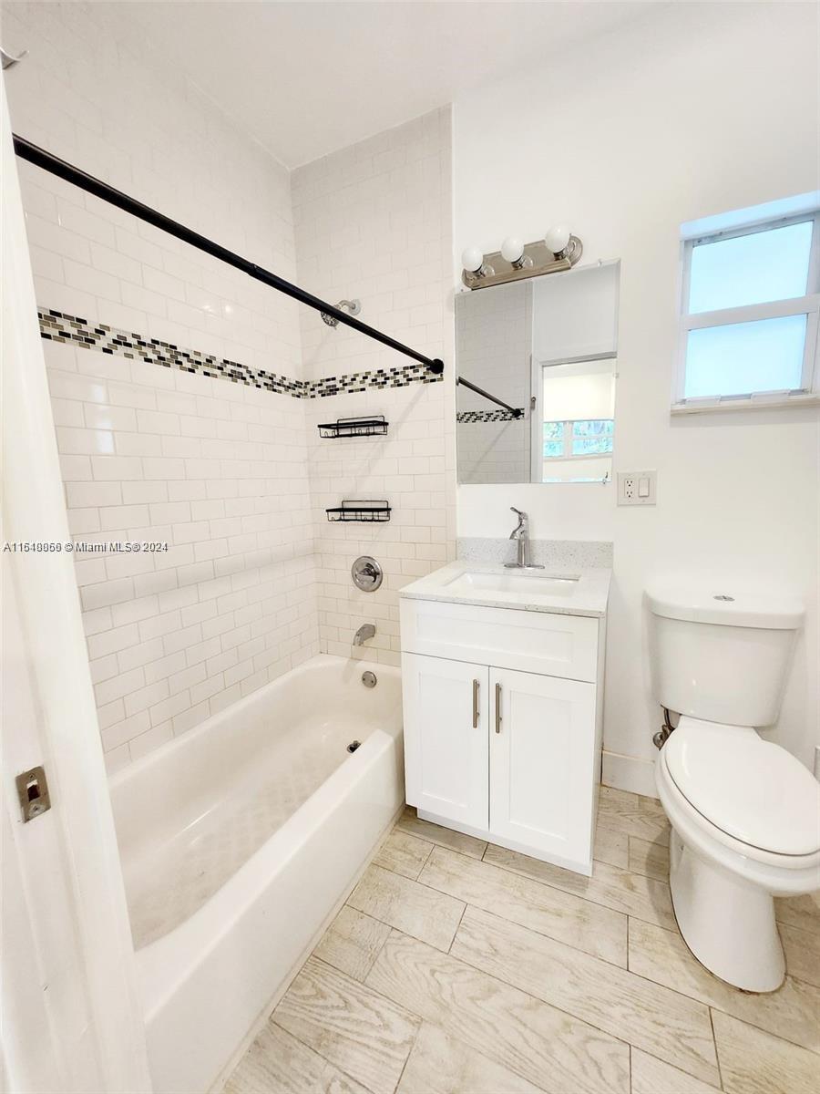 261 Northwest 50th Street, Unit R Miami, FL 33127 - Photo 8 of 10 a bathroom with a sink toilet and shower