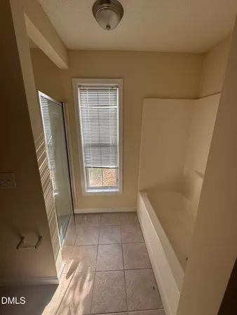 a bathroom with a granite countertop bathtub shower and vanity