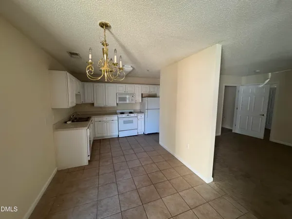 a kitchen with a stove a refrigerator and cabinets