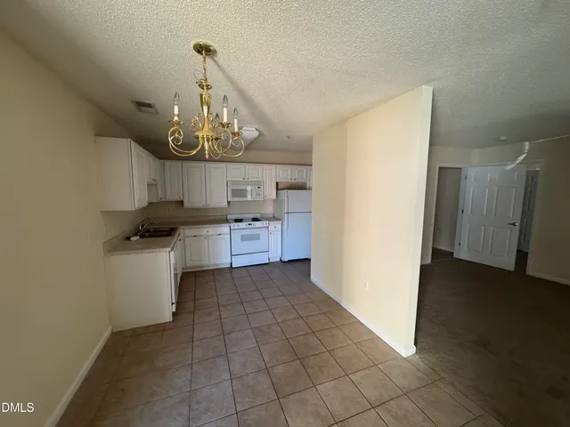 a kitchen with a stove a refrigerator and cabinets