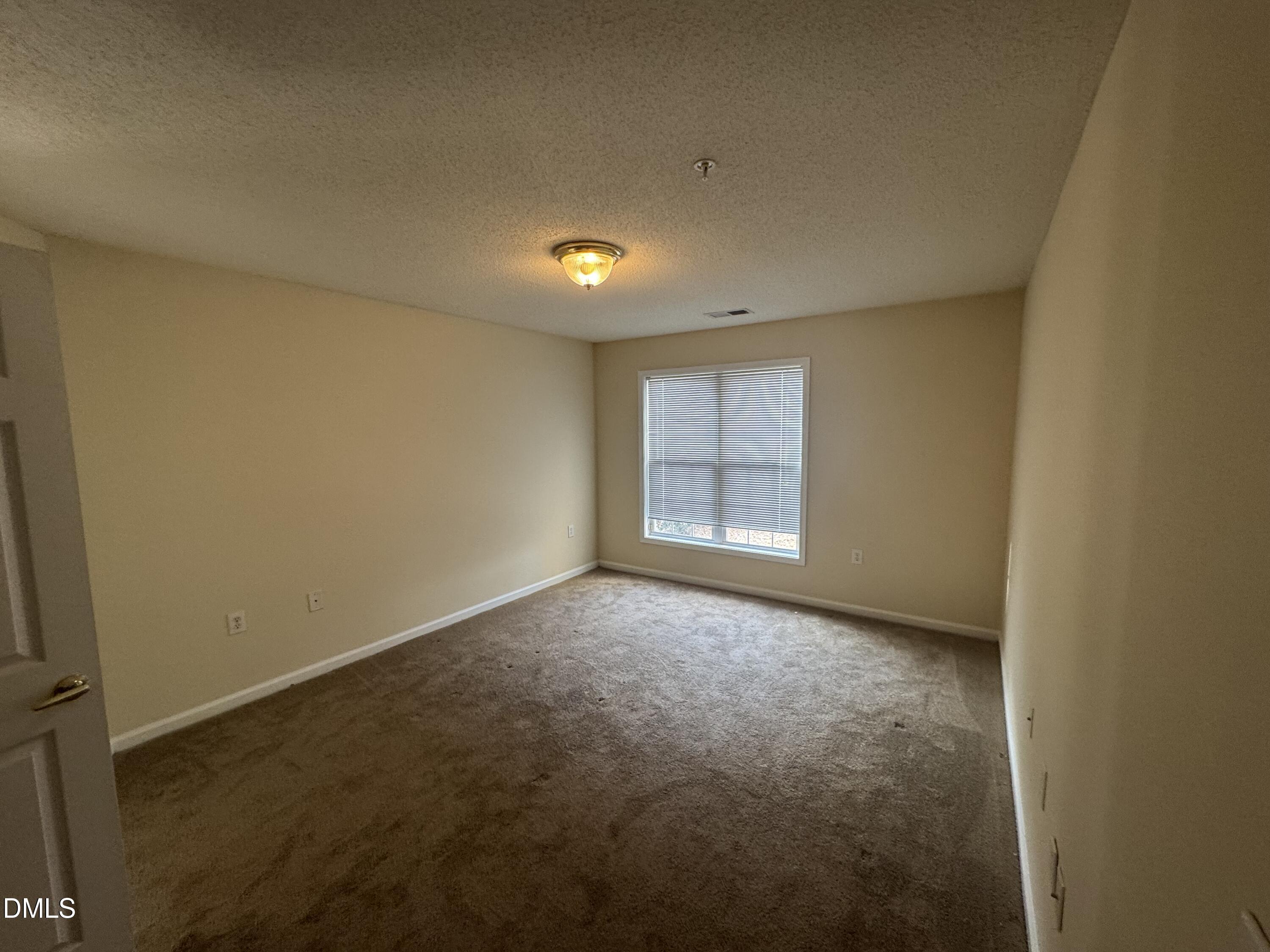 2511 Huntscroft Lane, Unit 101 Raleigh, NC 27617 - Photo 8 of 11 an empty room with windows