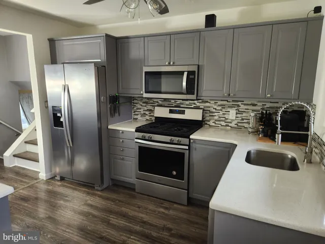 a kitchen with a sink a stove and refrigerator