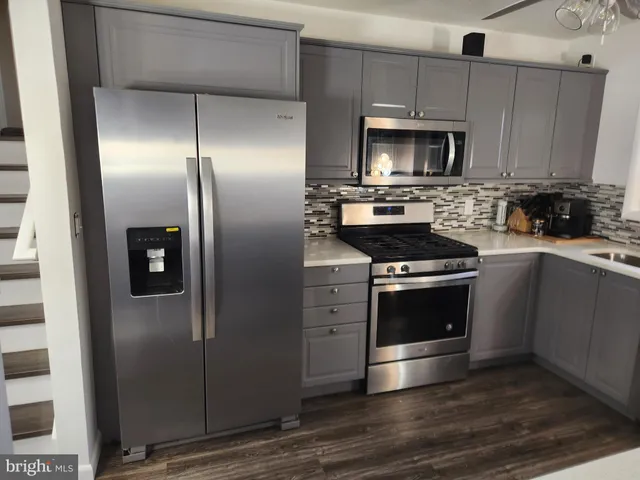 a kitchen with a refrigerator stove and microwave