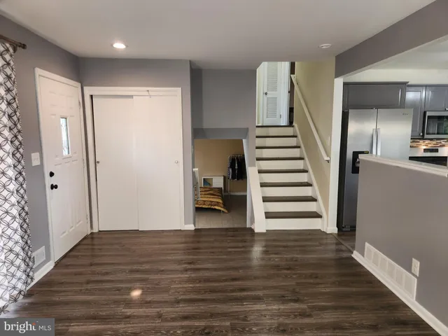 a view of entryway and hall with wooden floor