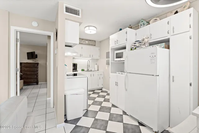 a kitchen with a refrigerator and cabinets